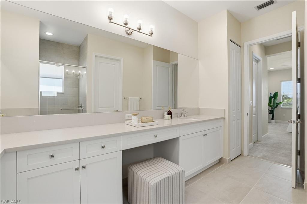 12391 Purple Ficus Way Naples, FL 34120 - Photo 29 of 47 a bathroom with a sink and a mirror