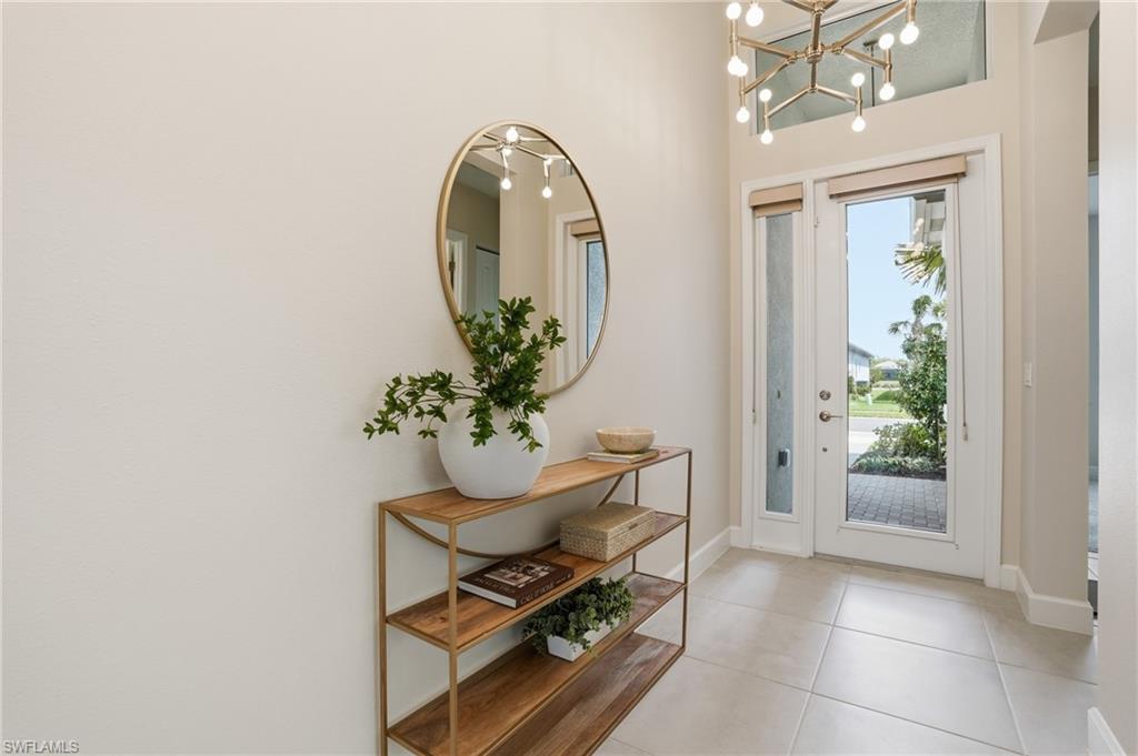 12391 Purple Ficus Way Naples, FL 34120 - Photo 4 of 47 a dining room with furniture and potted plant