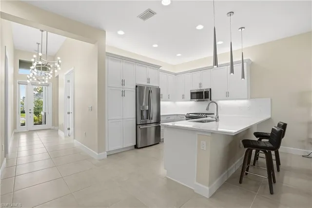 a kitchen with refrigerator and cabinets