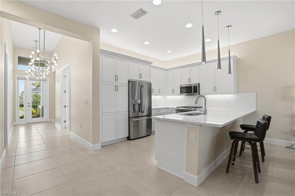 12391 Purple Ficus Way Naples, FL 34120 - Photo 5 of 44 Light and bright kitchen and foyer