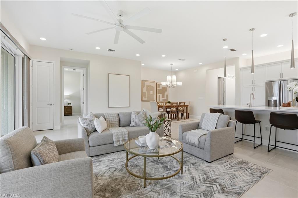 12391 Purple Ficus Way Naples, FL 34120 - Photo 8 of 47 a living room with furniture and a large window