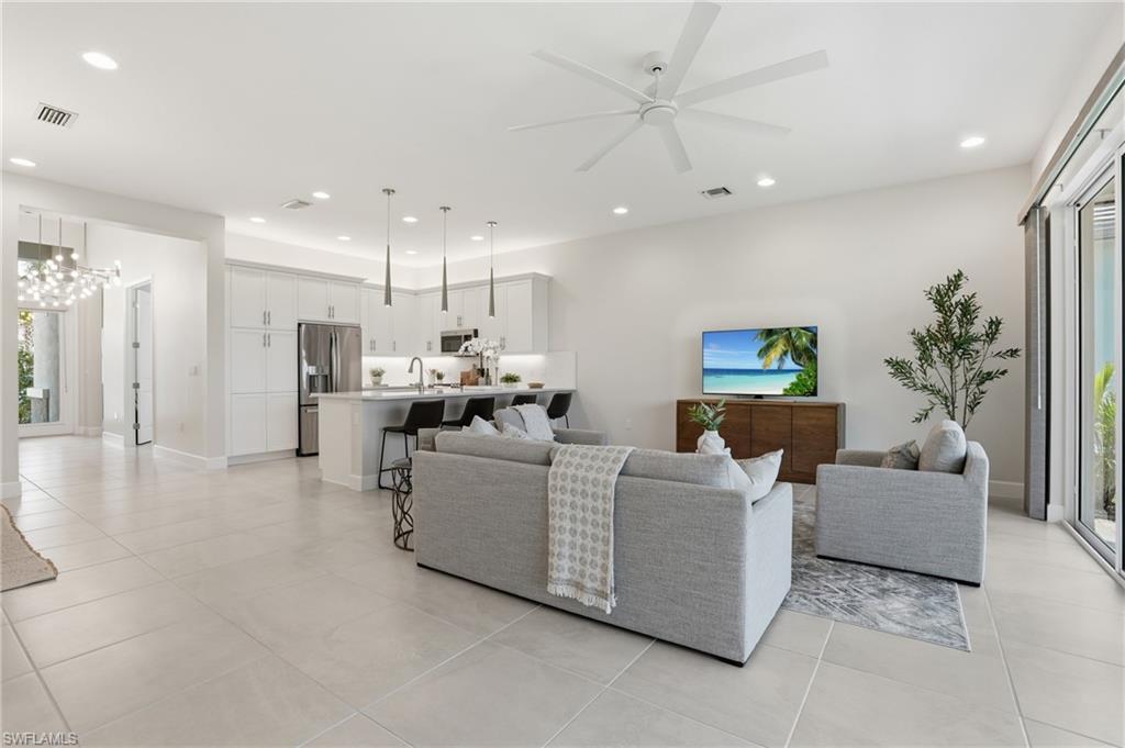 12391 Purple Ficus Way Naples, FL 34120 - Photo 9 of 47 a living room with furniture and a large window