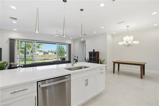 a large kitchen with stainless steel appliances granite countertop a stove and a sink