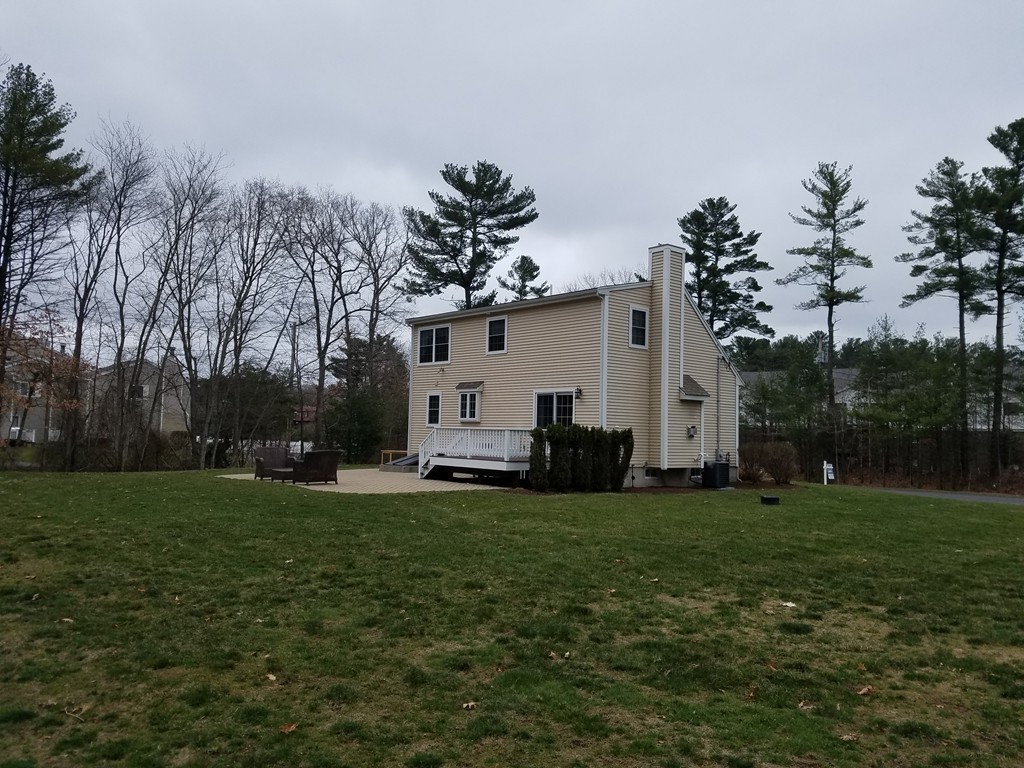 2 Erick Road Mansfield, MA 02048 - Photo 23 of 25 a view of a white house with a big yard and large trees