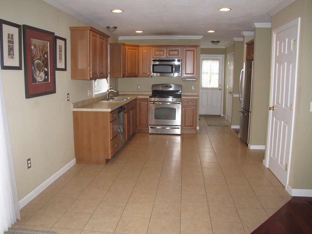 2 Erick Road Mansfield, MA 02048 - Photo 4 of 25 a kitchen with stainless steel appliances granite countertop a stove a sink and a refrigerator