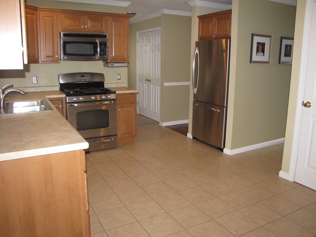 2 Erick Road Mansfield, MA 02048 - Photo 5 of 25 a kitchen with granite countertop a refrigerator and a stove top oven