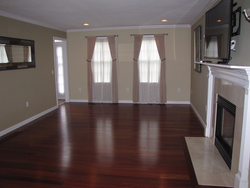 2 Erick Road Mansfield, MA 02048 - Photo 8 of 25 a view of an empty room with wooden floor and a window