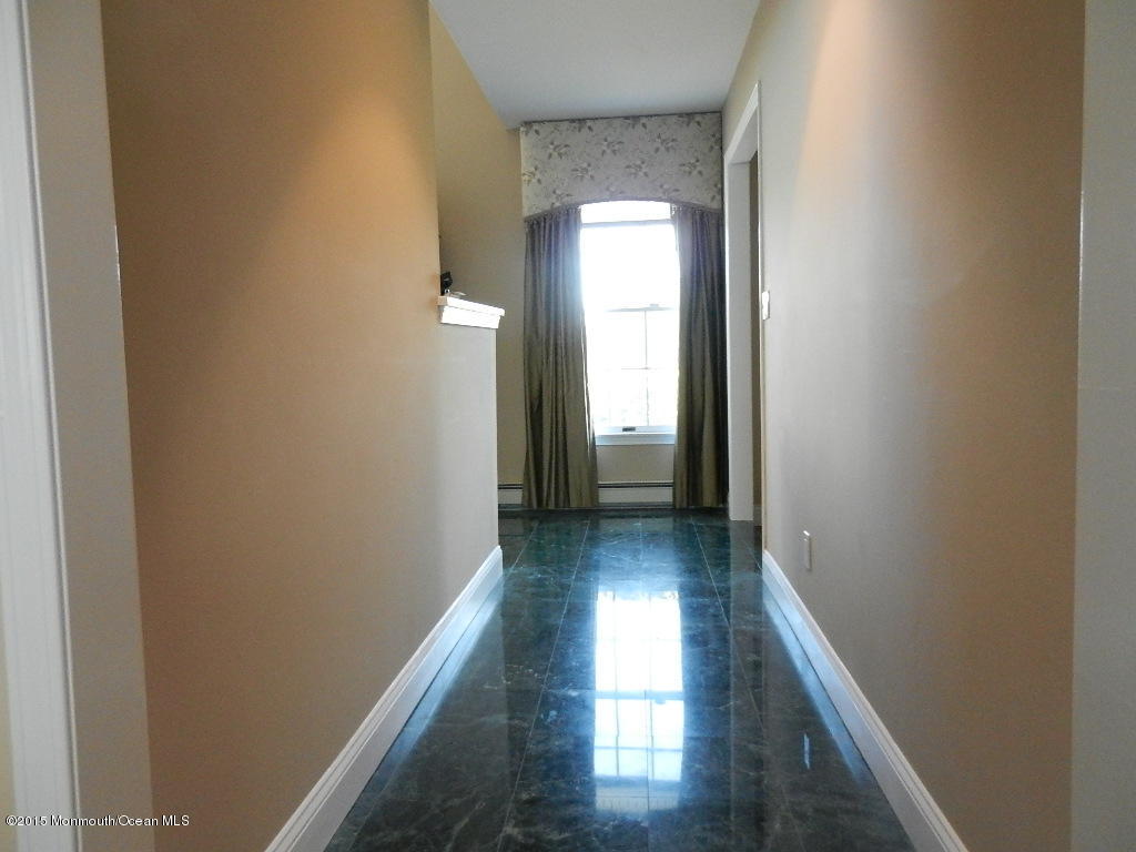 21 Statesboro Road Freehold, NJ 07728 - Photo 13 of 30 a view of a hallway with wooden floor and a window