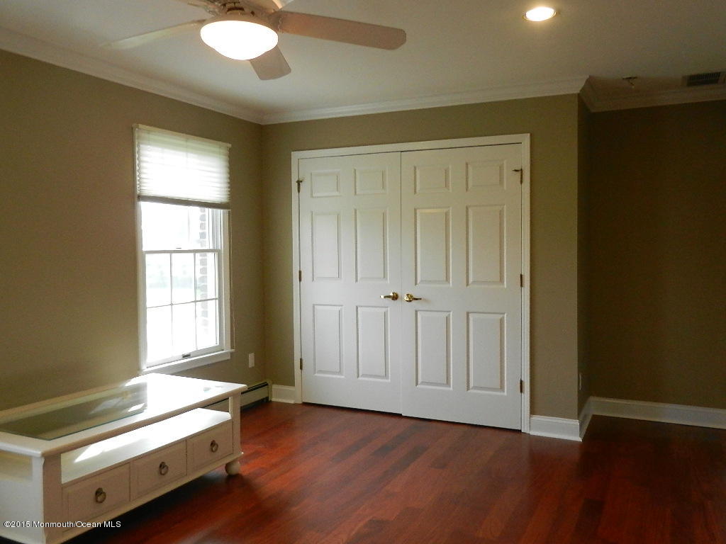 21 Statesboro Road Freehold, NJ 07728 - Photo 18 of 30 a view of an empty room with window and wooden floor