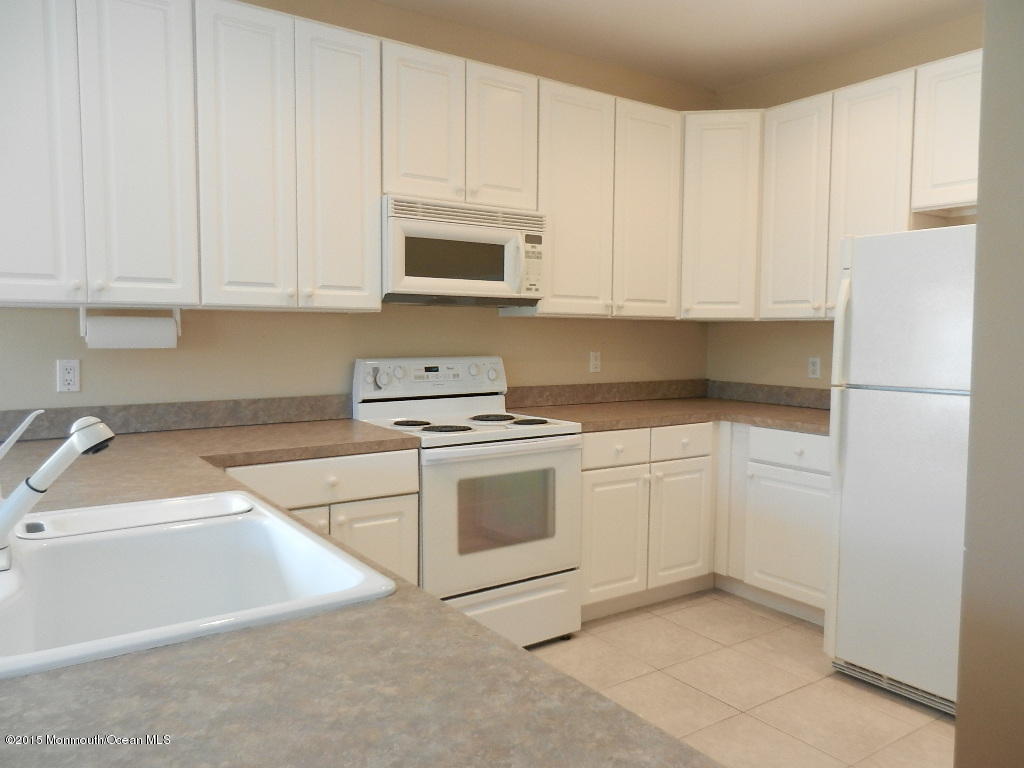 21 Statesboro Road Freehold, NJ 07728 - Photo 25 of 30 a kitchen with white cabinets and white appliances