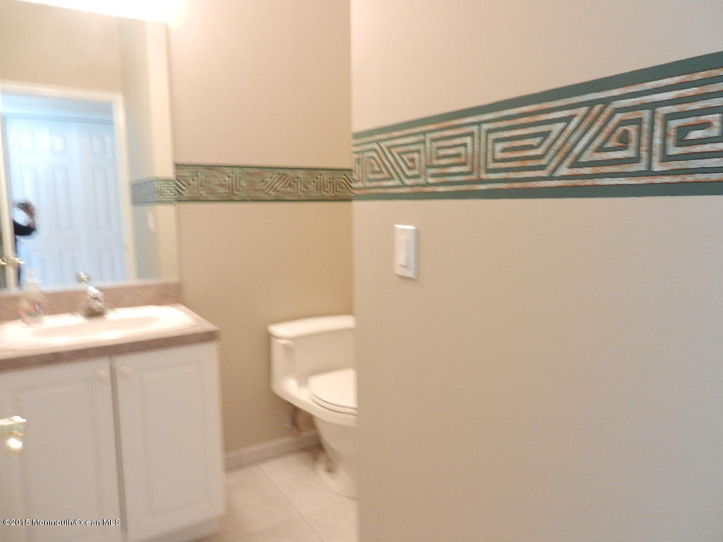 21 Statesboro Road Freehold, NJ 07728 - Photo 26 of 30 a bathroom with a sink a toilet and vanity