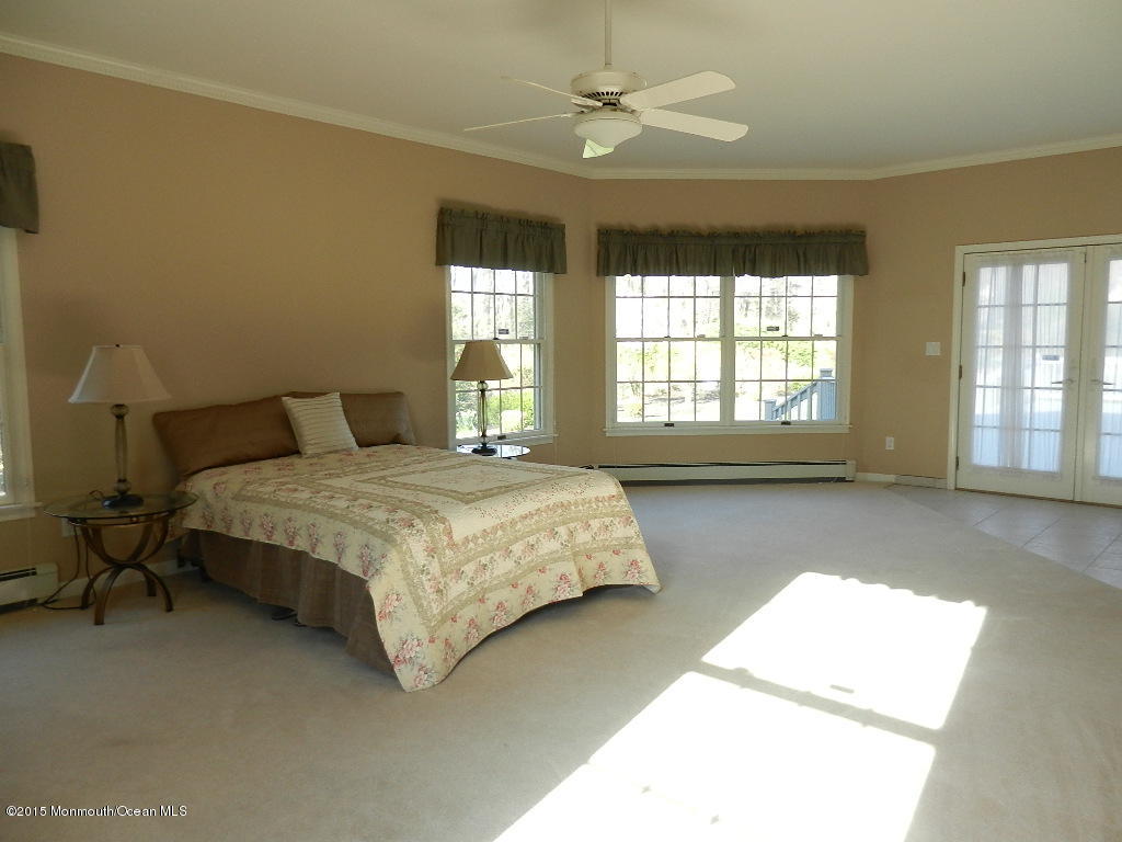 21 Statesboro Road Freehold, NJ 07728 - Photo 29 of 30 a bedroom with a bed mirror and window