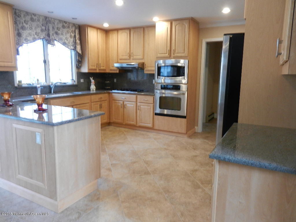 21 Statesboro Road Freehold, NJ 07728 - Photo 7 of 30 a kitchen with stainless steel appliances granite countertop a refrigerator sink and stove