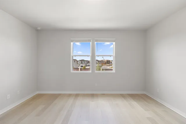 a large white room with kitchen island a sink wooden floor and entryway