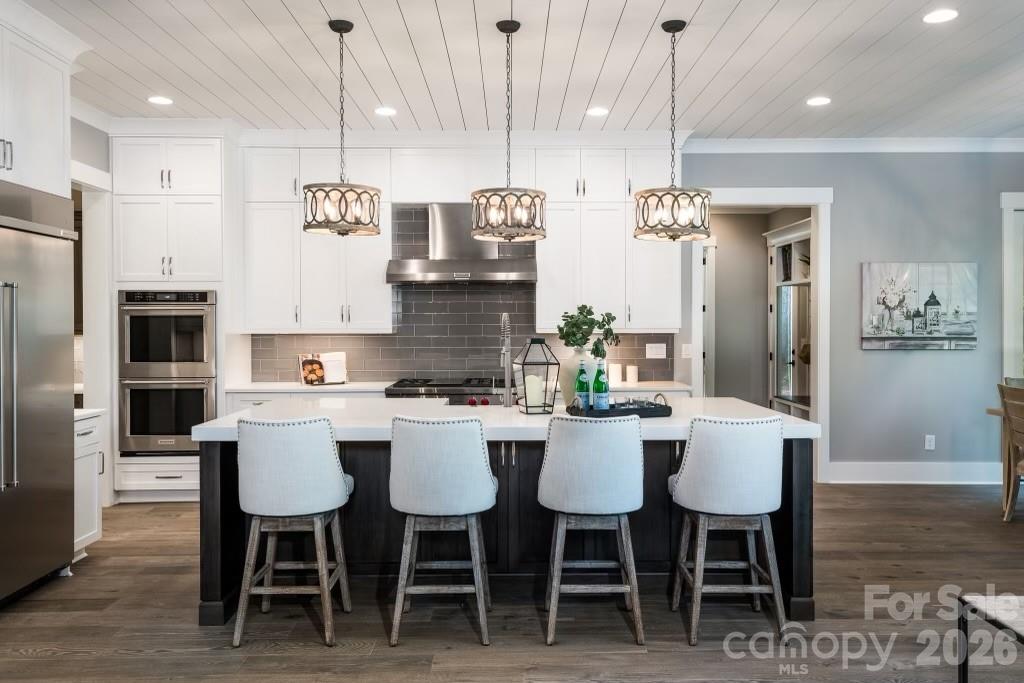 116 Silver Falls Road Troutman, NC 28166 - Photo 20 of 46 a large kitchen with a table and chairs