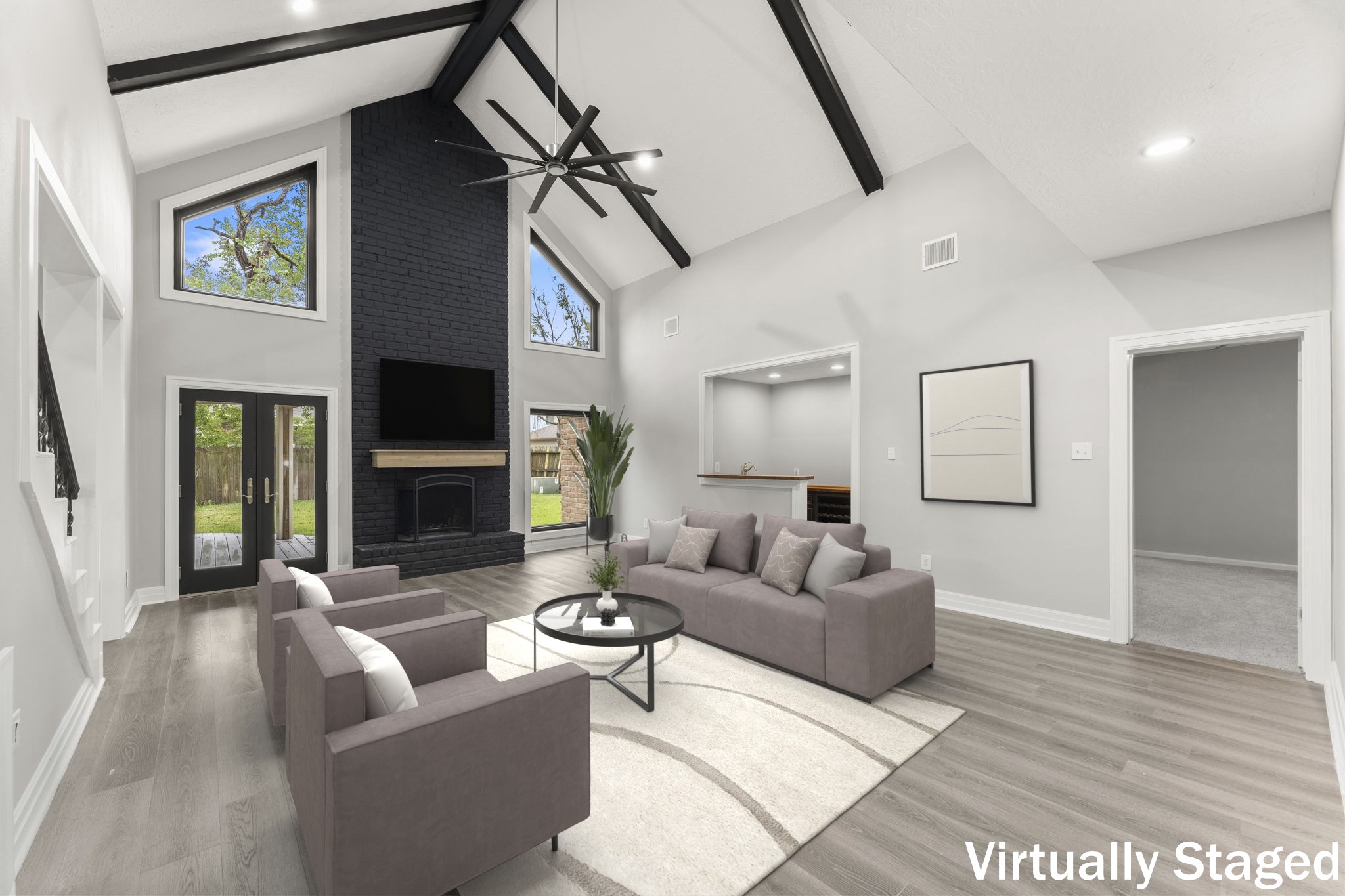 Soaring ceilings with new windows & French doors, gorgeous beams and show stopper fireplace!