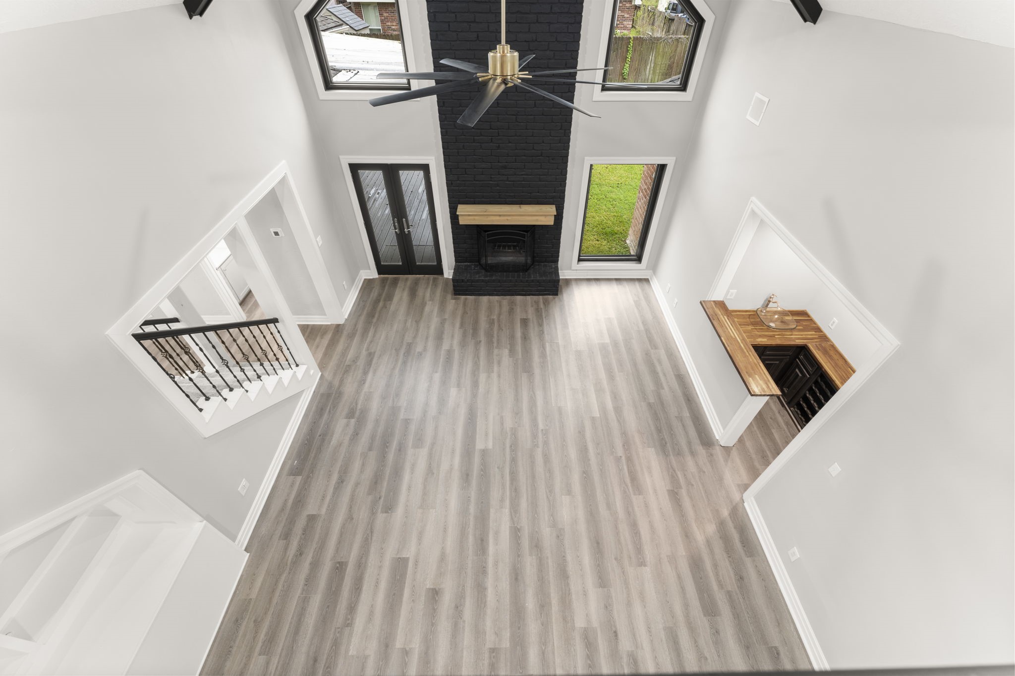 6415 Singing Creek Lane Spring, TX 77379 - Photo 11 of 34 Check out the view from the upstairs hall! There's all new paint and flooring in this family room with a cool wet bar and built ins.