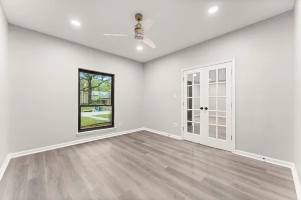 an empty room with windows and closet