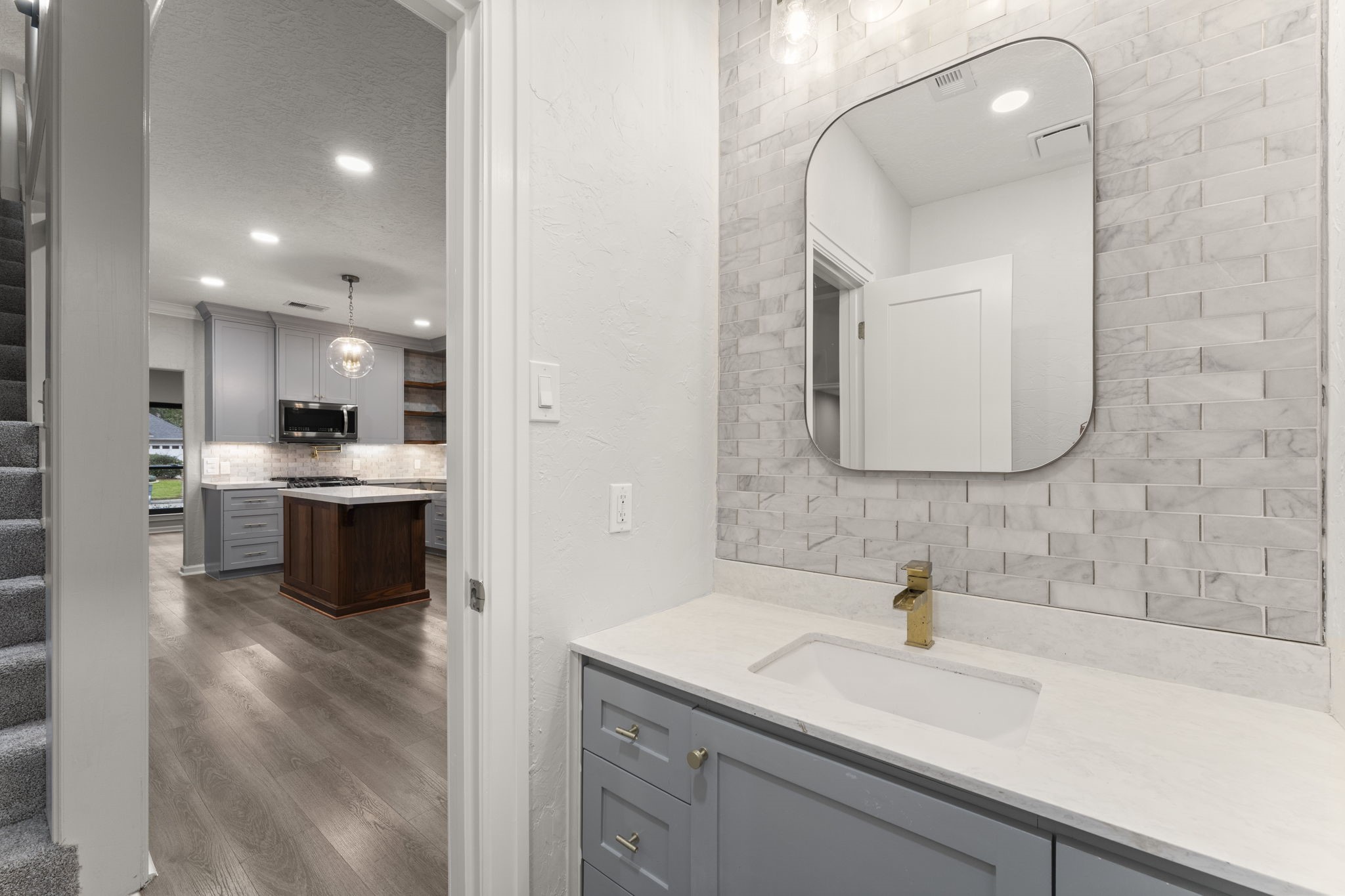 6415 Singing Creek Lane Spring, TX 77379 - Photo 15 of 34 The half bath downstairs has been completely remodeled with timeless, high quality finishes.