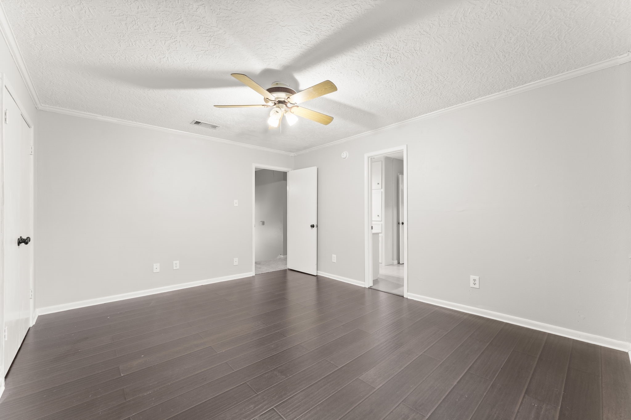 6415 Singing Creek Lane Spring, TX 77379 - Photo 23 of 29 an empty room with wooden floor fan and windows