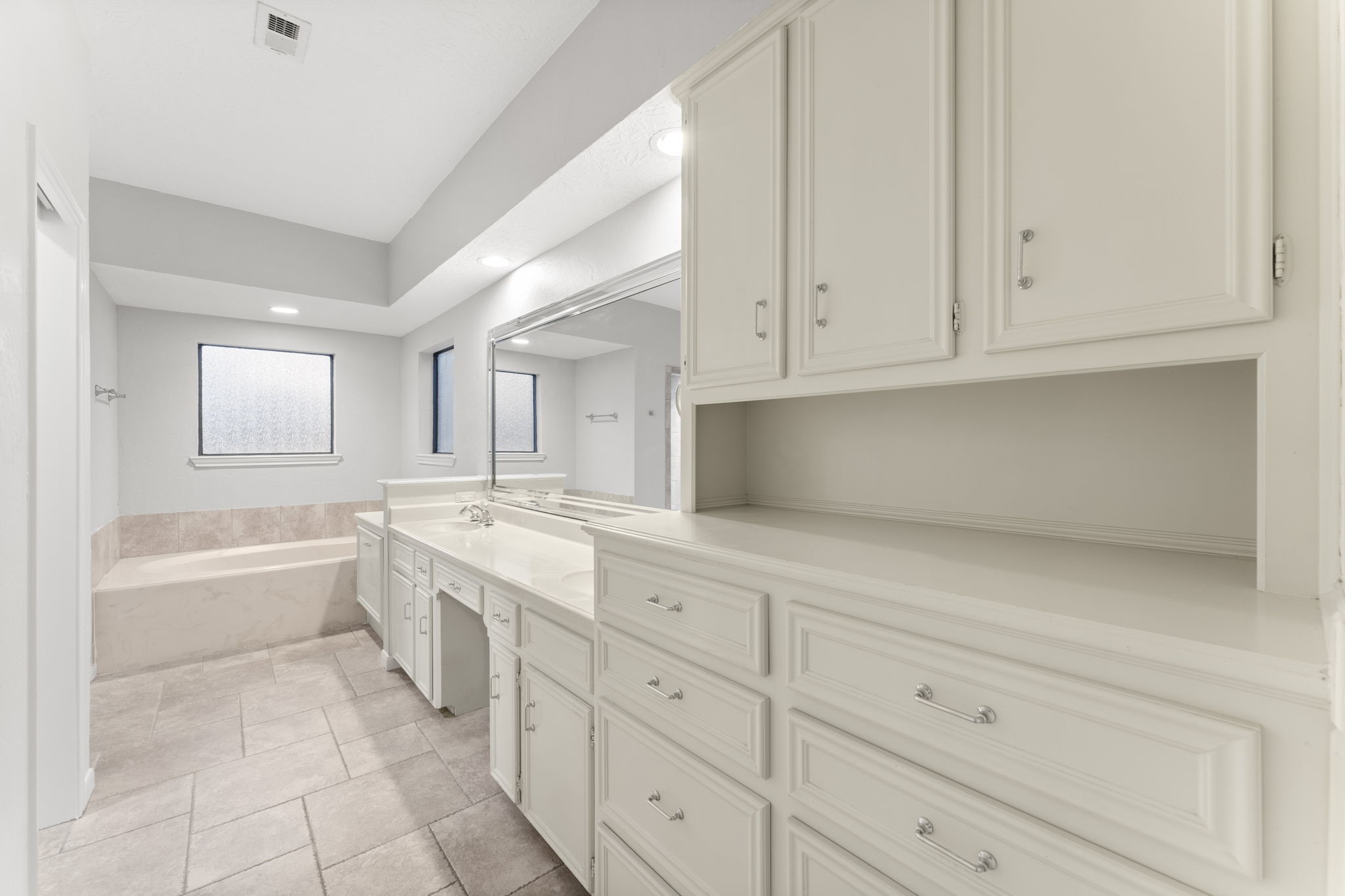 6415 Singing Creek Lane Spring, TX 77379 - Photo 23 of 34 The downstairs primary ensuite has so many cabinets for keeping neat and tidy!