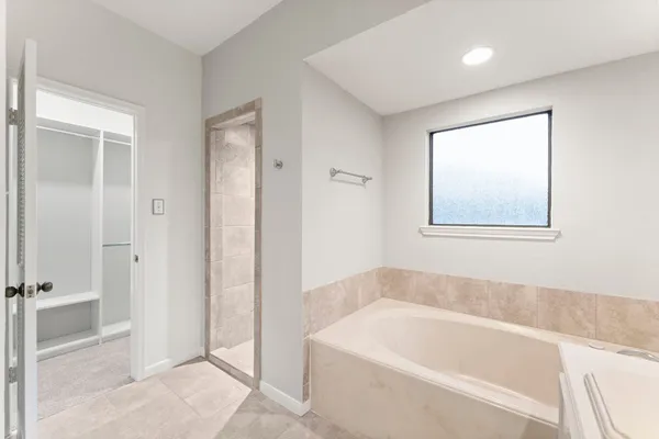a bathroom with a bathtub and a shower