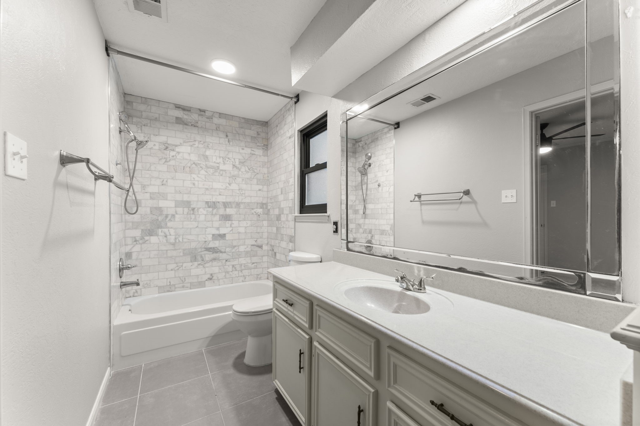 6415 Singing Creek Lane Spring, TX 77379 - Photo 26 of 34 The upstairs ensuite has and updated marble tub surround and fixtures.