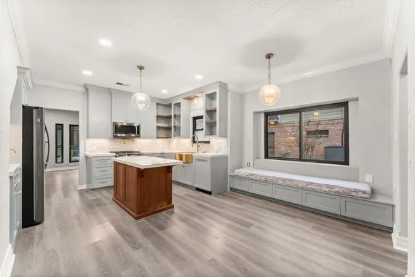 a large kitchen with a large counter top appliances and cabinets