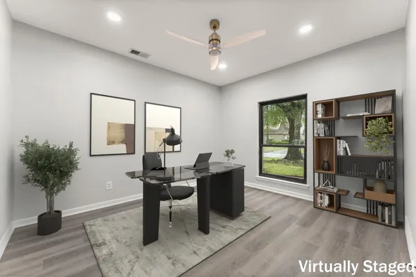 a view of a livingroom with workspace and a window