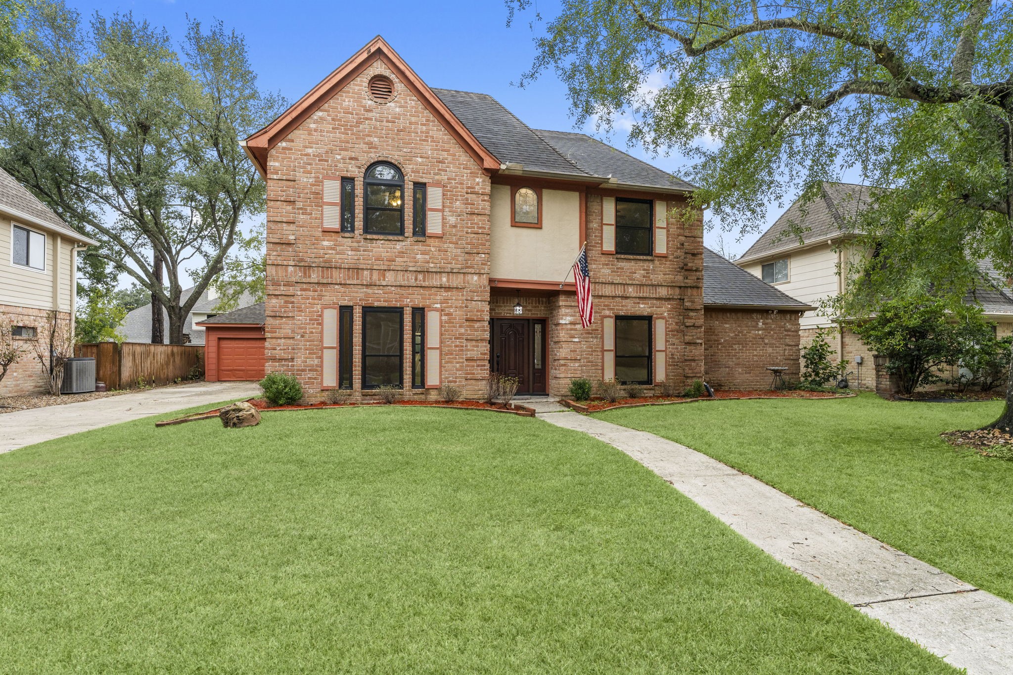 6415 Singing Creek Lane Spring, TX 77379 - Photo 9 of 29 a front view of a house with a yard and garage