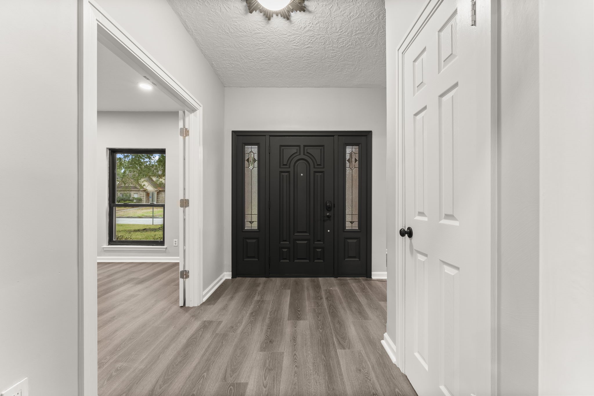 6415 Singing Creek Lane Spring, TX 77379 - Photo 10 of 29 a view of a hallway with wooden floor and staircase