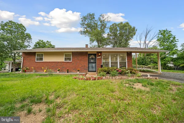 a view of a house with backyard sitting area and garden