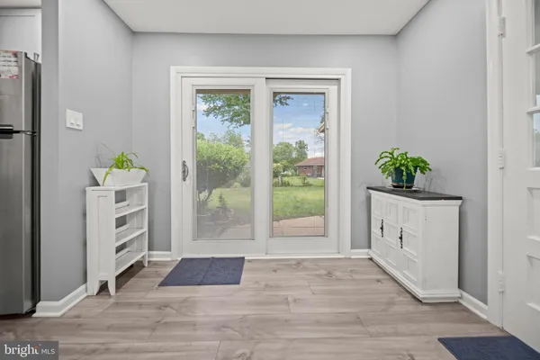 a view of an entryway with wooden floor and cabinet