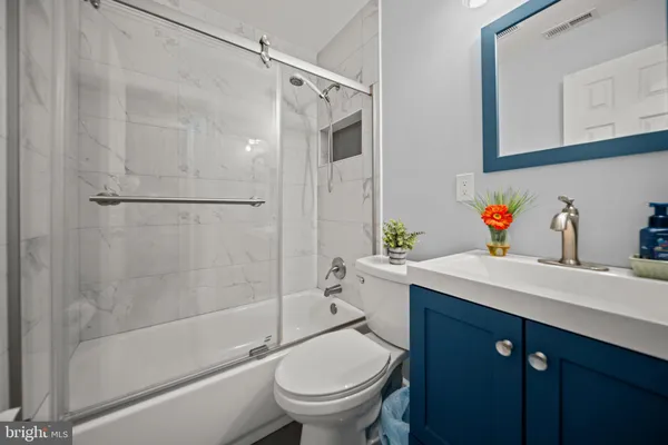 a bathroom with a sink toilet and shower