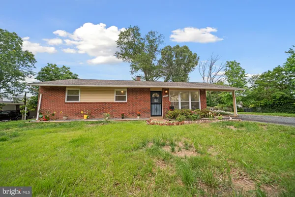 a front view of house with a garden and patio