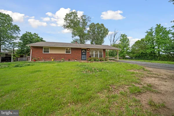 a house view with swimming pool and garden space