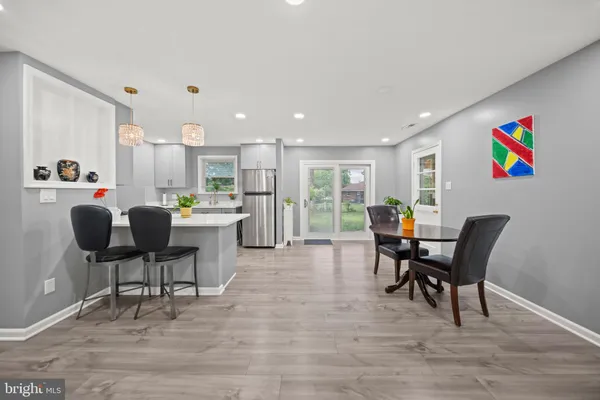 a view of a dining room with furniture and a potted plant