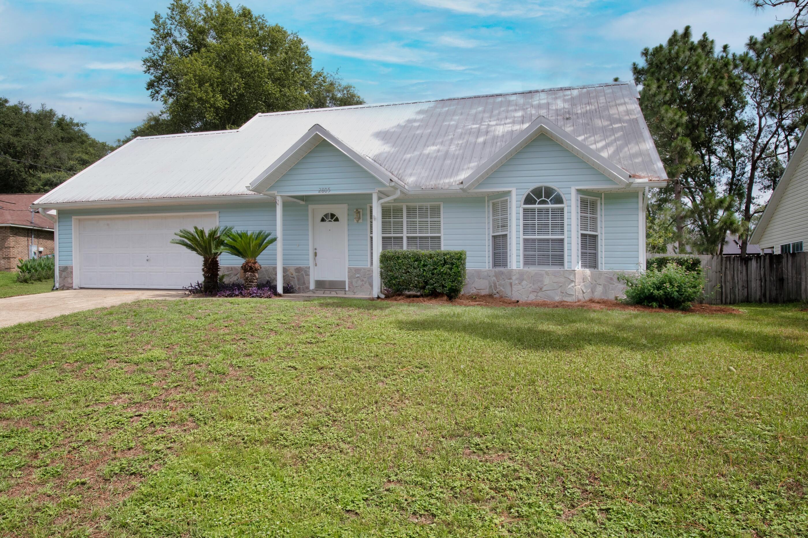 2805 Ping Lane Crestview, FL 32539 - Photo 3 of 30 a front view of a house with a garden and yard