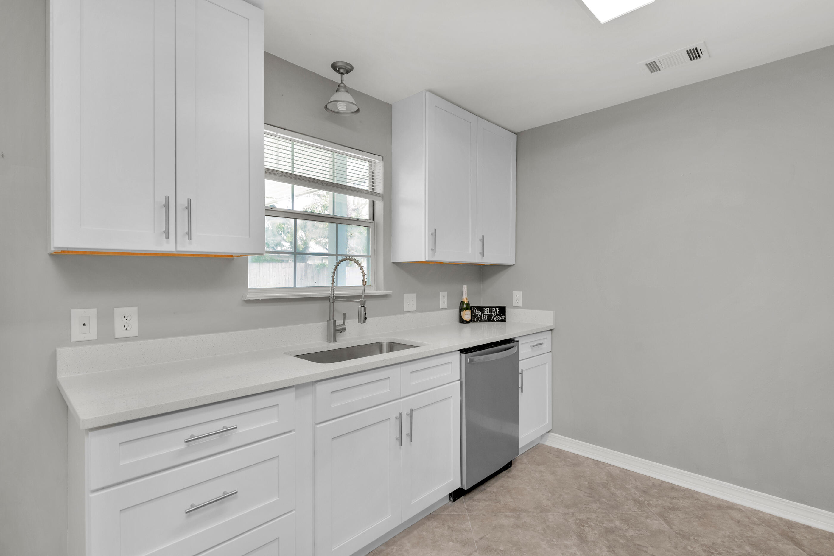 2805 Ping Lane Crestview, FL 32539 - Photo 6 of 30 a kitchen with granite countertop white cabinets and white appliances