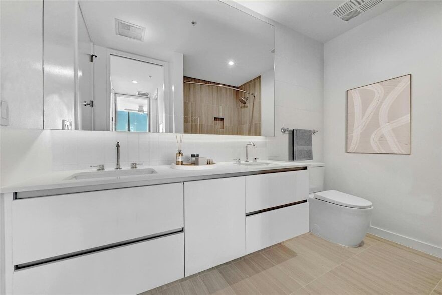 313 West 17th Street, Unit 2003 Austin, TX 78701 - Photo 12 of 25 a bathroom with a sink toilet and a mirror