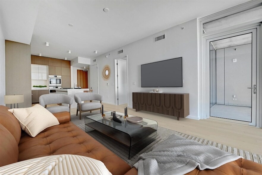 313 West 17th Street, Unit 2003 Austin, TX 78701 - Photo 23 of 25 a living room with furniture and a flat screen tv