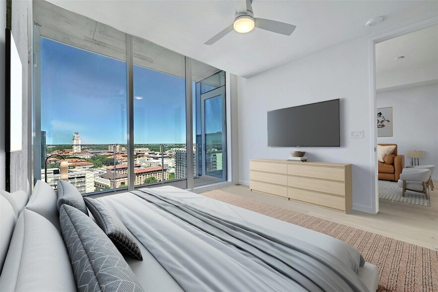 313 West 17th Street, Unit 2003 Austin, TX 78701 - Photo 24 of 25 a bedroom with a bed and flat screen tv