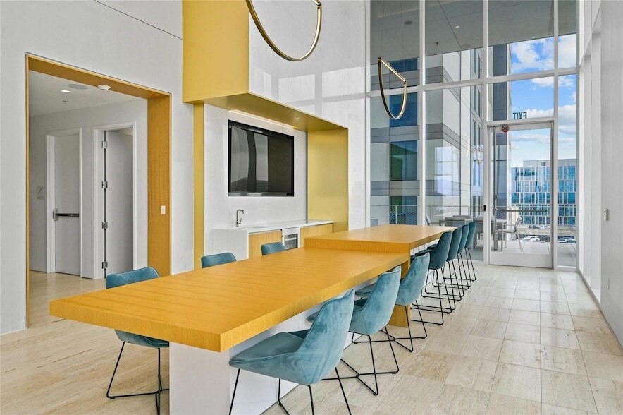 313 West 17th Street, Unit 2003 Austin, TX 78701 - Photo 5 of 25 a dining room with a table chairs and a chandelier