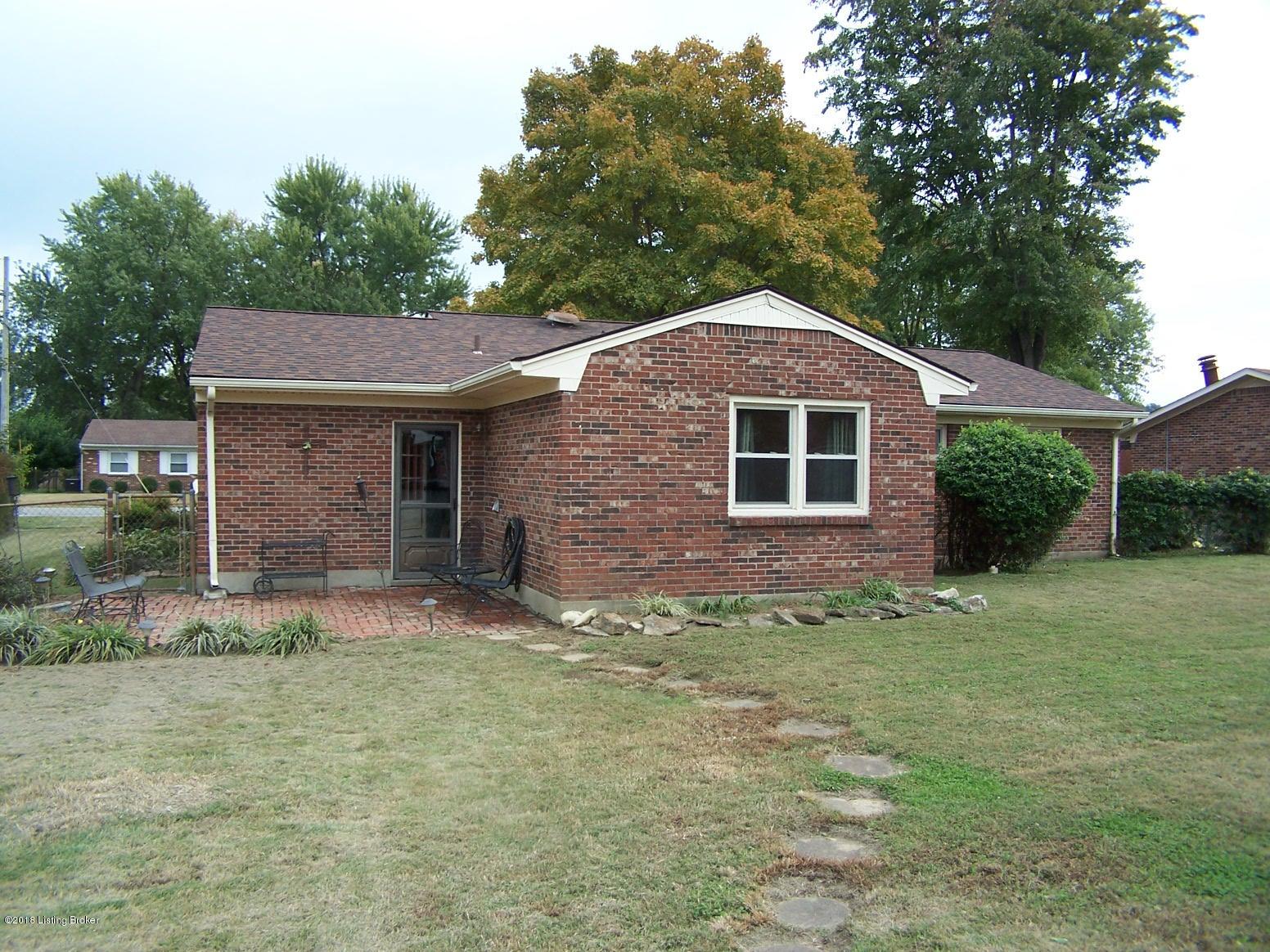 11004 Torrington Road Louisville, KY 40272 - Photo 17 of 43 Rear view of this all brick 3 Bedroom home with 1 updated Full Bath, Living Room, added Family Room on the back, Eat-In Area in Kitchen, Laundry Room, 1 Car Attached Garage, Covered Front Porch, Replacement Windows, ALL new Carpeting, New Paint, Fully Fenced Back Yard, Utility Shed and an above ground pool with a tanning deck.