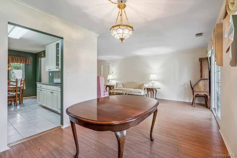 914 Fenway Road St. James, NY 11780 - Photo 12 of 35 a view of a dining room with furniture and a chandelier