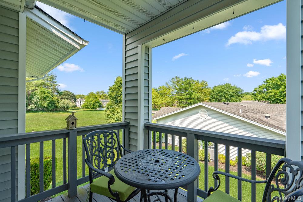 914 Fenway Road St. James, NY 11780 - Photo 27 of 35 a view of a balcony with a table and chairs