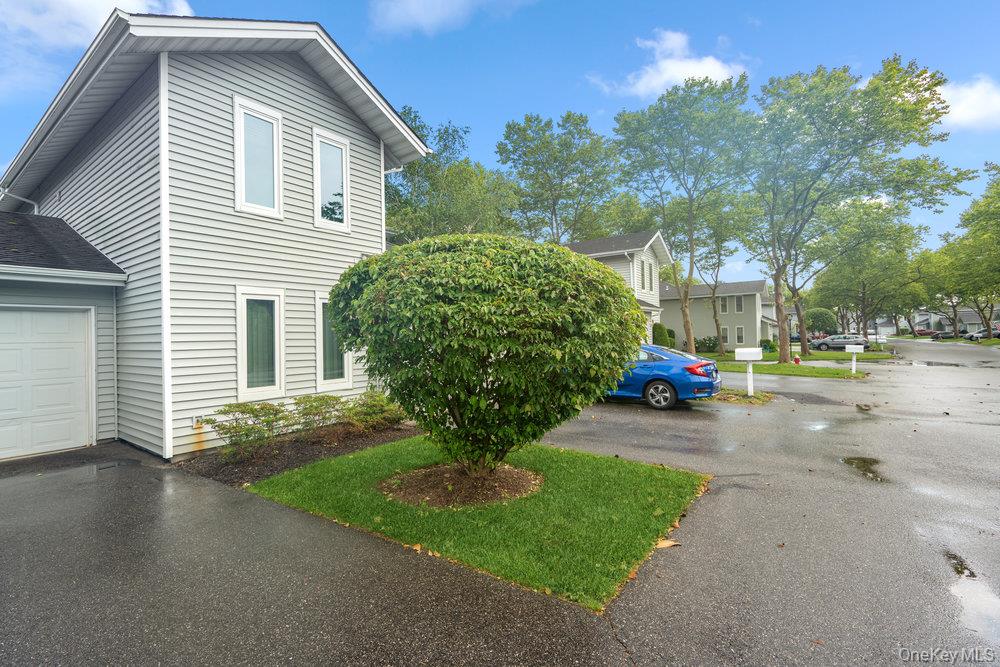 914 Fenway Road St. James, NY 11780 - Photo 3 of 35 a view of a house with a yard and garage