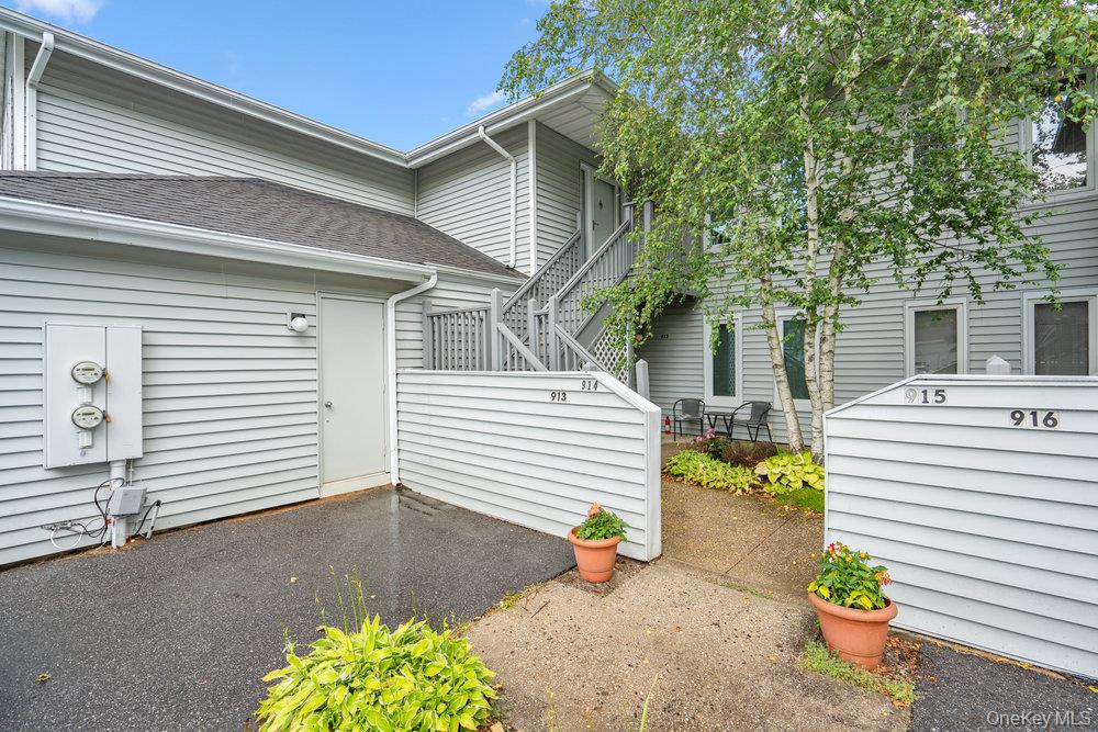 914 Fenway Road St. James, NY 11780 - Photo 4 of 35 a view of a patio with table and chairs potted plants