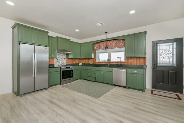 a kitchen with a sink and wooden cabinets