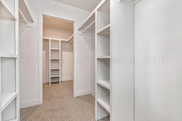 a view of closet area with empty racks